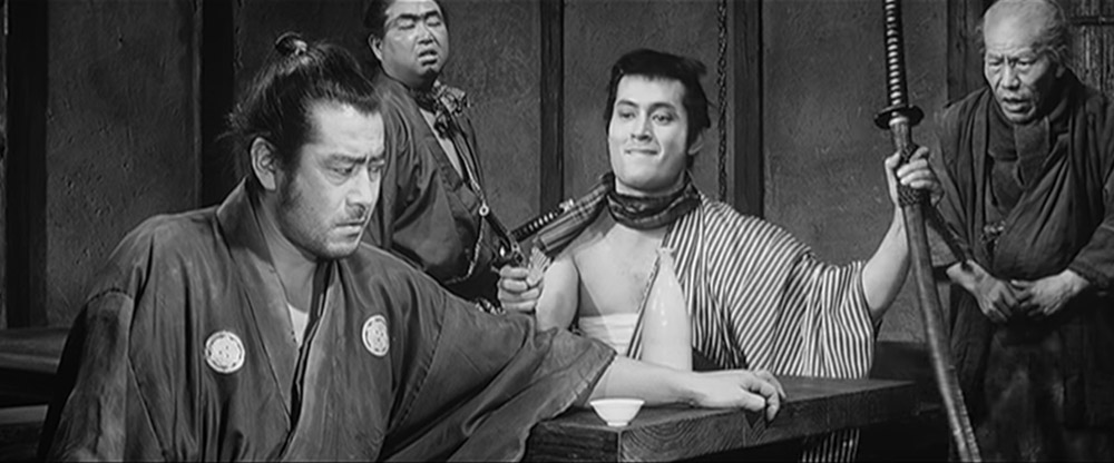 yojimbo sitting at table - top 10 best samurai movies